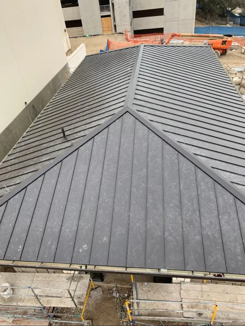 Commercial metal roof construction with crane equipment in Cherry Hill